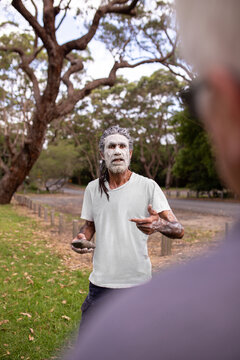 aboriginal man explaining his people's history to a visitor
