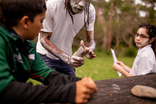dharawal man explaining how sacred rocks were used by previous generations