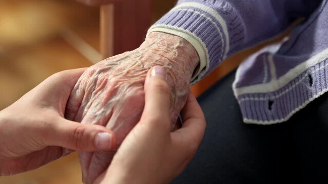 Helping hands, care for the elderly concept. High quality 4k footage.