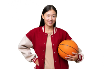 Young basketball player asian woman over isolated background posing with arms at hip and smiling