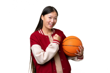 Young basketball player asian woman over isolated background celebrating a victory