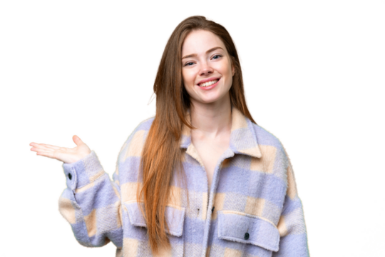 Young pretty woman over isolated chroma key background holding copyspace imaginary on the palm to insert an ad