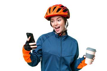 Young cyclist woman over isolated chroma key background holding coffee to take away and a mobile