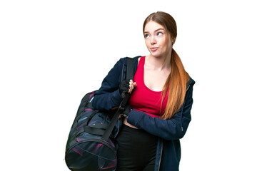 Young sport woman with sport bag over isolated chroma key background making doubts gesture while lifting the shoulders