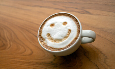 Cup of cappuccino coffee delicious hot coffee with foam milk and smile on color background, top...