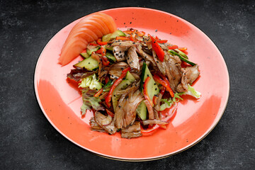Salad with meat, fresh vegetables and sesame