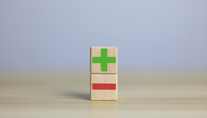 wooden blocks with plus and minus signs Comparatively opposite concepts Analyze differences to...