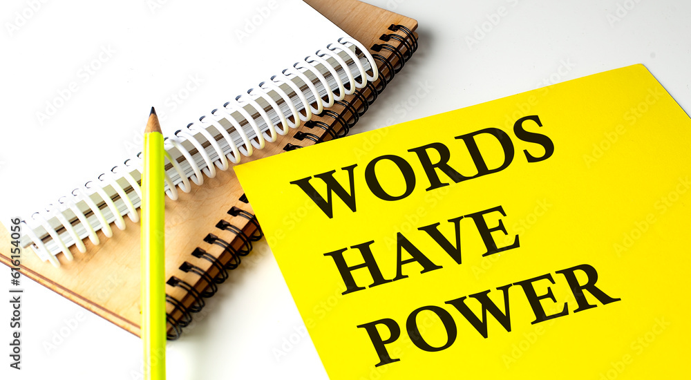 Aufkleber words have power text written on a yellow paper with notebook