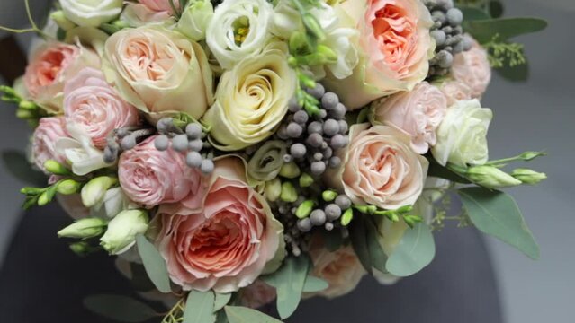 Top view close up of beautiful modern wedding bouquet of roses for bride.