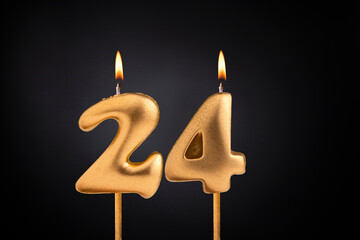 Golden candle 24 with flame - Birthday card on dark luxury background