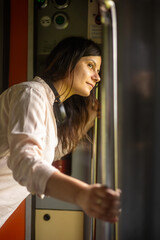 portrait of a woman looking out the window in the train