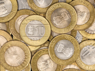 a mixed collection of rare vintage indian bimetallic 10 (ten) rupee coins gold and silver in a pile 