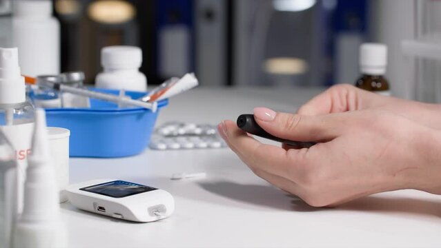 modern medicine, charming woman collects a glucometer to check blood sugar levels, close-up