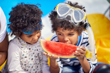 Refreshing Poolside Protein Snack: Little Brother and Sister Enjoying Watermelon