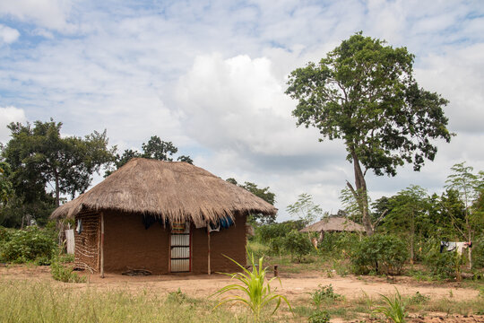 Typical rural mud-house in remote village in Africa with thatched roof, very basic and poor living conditions
