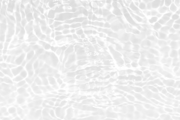 White water with ripples on the surface. Defocus blurred transparent white colored clear calm water surface texture with splashes and bubbles. Water waves with shining pattern texture background.