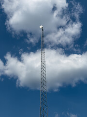 Obraz premium Radio Tower with Blue Skies and Clouds