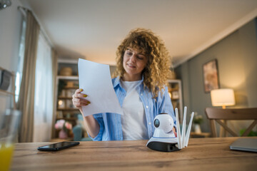 adult caucasian woman adjust prepare home surveillance security camera