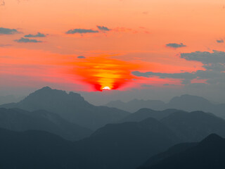 Fototapeta na wymiar Orange Purple Sunset in the Alps in Tarvisio (Monte Lusssari) Italy