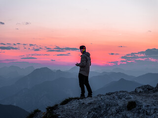 Tourist Staring at the Sunset in the Alps in Tarvisio (Monte Lussari) Italy