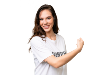 Young volunteer caucasian woman over isolated background pointing back