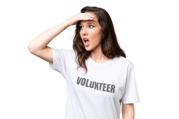 Young volunteer caucasian woman over isolated background doing surprise gesture while looking to the side