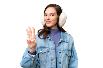 Young caucasian woman wearing winter muffs over isolated background happy and counting three with...