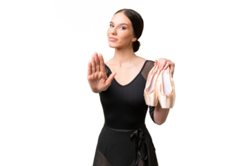Young caucasian woman practicing ballet over isolated background making stop gesture