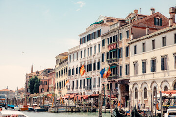 Fototapeta na wymiar Venice's Canal-Side Buildings with Gondola Stations