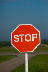 Obraz premium Stop sign on a rural road. Selective focus with shallow depth of field.