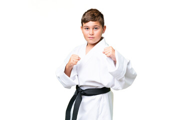 Little caucasian kid over isolated chroma key background doing karate