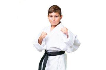 Little caucasian kid over isolated chroma key background doing karate