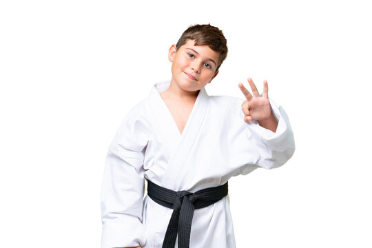 Little caucasian kid doing karate over isolated chroma key background happy and counting three with fingers