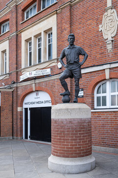 Fulham Football Clubs Craven Cottage stadium, view of the media office with statue of Fulham legend Johnny Haynes in foreground, and 'FFC' logo in stone on the wall behind