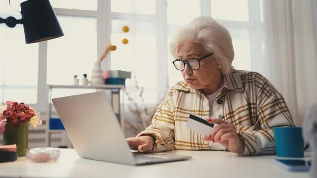 Senior woman having problems with online payment, blocked credit card, overdraft
