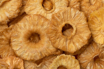 Dried pineapple slices close up full frame as background