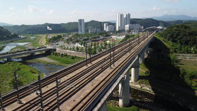 Aerial view of a train passing through Ulsan station in summer, Ulsan, South Korea.