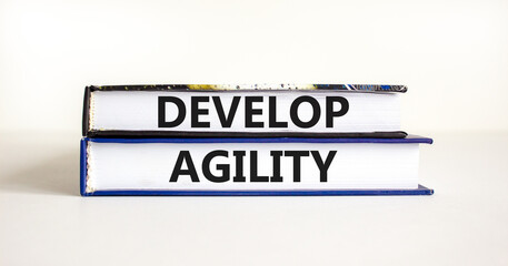 Develop agility symbol. Concept words Develop agility on beautiful books on a beautiful white table white background. Business, support and develop agility concept. Copy space.