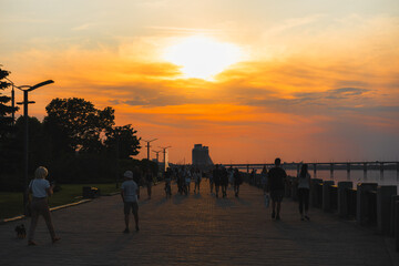 Panoramic view of the city of Dnipro during sunset or sunrise. Amazing sunset at Dnipro river with a view of the historical center. Warm days. background image. Ukrainian city.