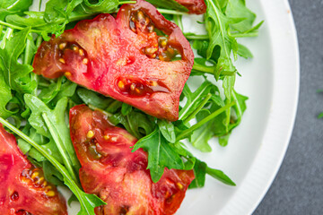 salad tomato arugula healthy meal food snack on the table copy space food background rustic top view keto or paleo diet veggie vegan or vegetarian food