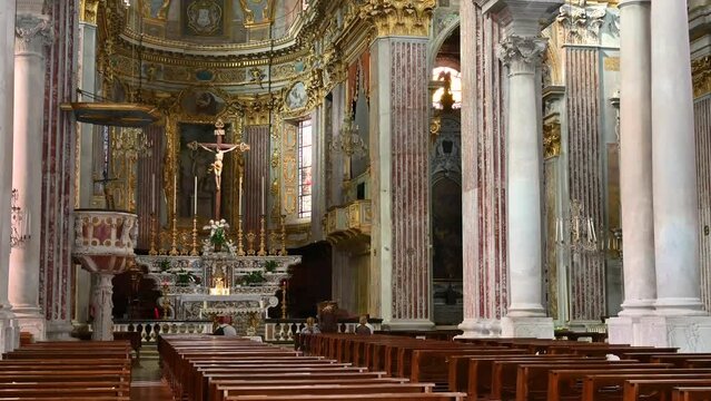 Finale Ligure Marina, Province of Savona, Liguria, Italy. September 20, 2020. Titl view of the magnificent interior of the Church of San Giovanni Battista. People gathered in prayer
