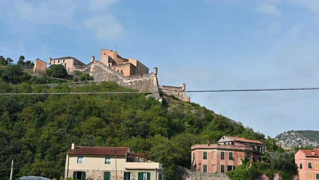 Finalborgo,Province of Savona, Liguria, Italy. September 20, 2020. Nice tilt footage of the fortification on the top of the hill overlooking the village. Beautiful summer day. Charm and beauty.