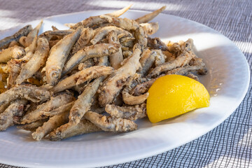 Plateful of Battered and Fried Smelts Served with a Wedge of Lemon in an Outdoor Restaurant in Symi, Greece