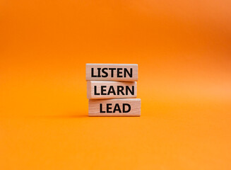 Listen Learn Lead symbol. Concept words Listen Learn Lead on wooden blocks. Beautiful orange background. Business and Listen Learn Lead concept. Copy space.