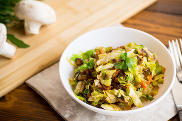 cabbage early fried with mushrooms, carrots and vegetables