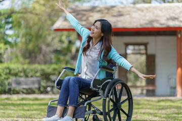 Obraz premium Young asian woman in wheelchair with positive thinking.