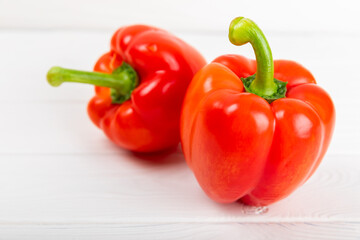 Fresh colorful red bell pepper on white textured wooden background. Bell pepper. Vegetables. Vegan food. Healthy foods. Place for text. Place to copy. Diet concept.