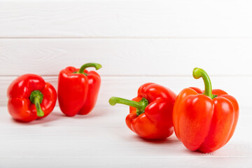 Fresh colorful red bell pepper on white textured wooden background. Bell pepper. Vegetables. Vegan food. Healthy foods. Place for text. Place to copy. Diet concept.