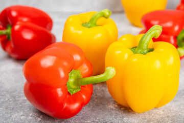 Fresh colorful red and yellow bell peppers on marble background. Bell pepper. Vegetables. Vegan food. Healthy foods. Place for text. Place to copy. Diet concept.