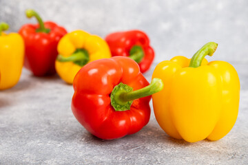 Fresh colorful red and yellow bell peppers on marble background. Bell pepper. Vegetables. Vegan food. Healthy foods. Place for text. Place to copy. Diet concept.
